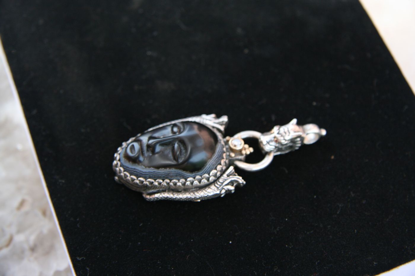 Buddha-Face Agate Pendant — Carved agate, ruby, diamond, silver